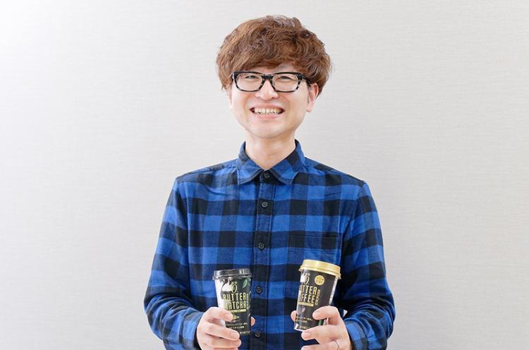 【嘉藤さん】「バターコーヒーオリジナル」と「バター抹茶」を手に持ち、笑顔の嘉藤さん